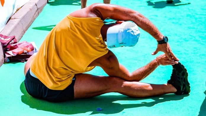 Person stretching to prevent workout injuries
