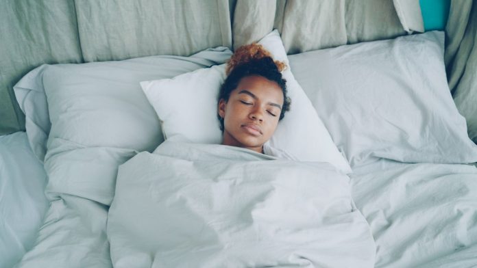 Woman sleeping peacefully in bed during the night