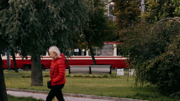 Woman walking outdoors on a park path for fitness