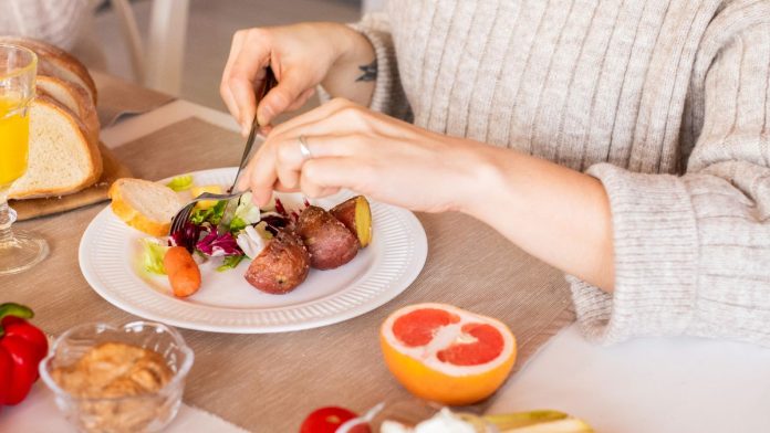 Woman enjoying a fresh colorful vegetable salad
