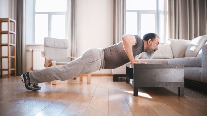 Man doing push-ups during a bodyweight workout at home