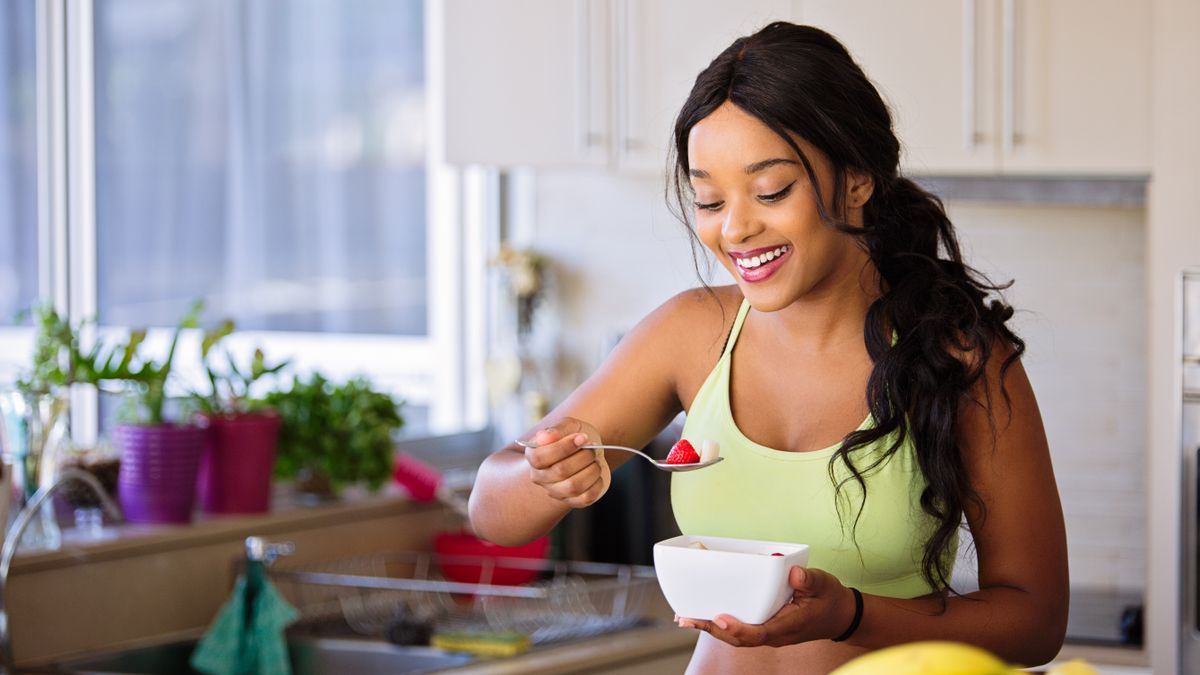 Woman eating a healthy meal while losing weight in a calorie deficit