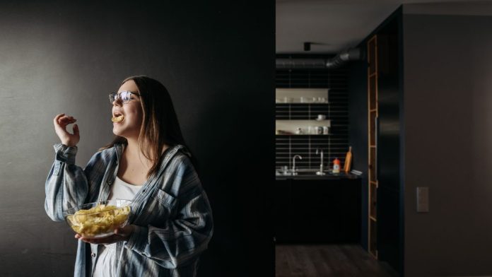Woman reaching for a snack in the kitchen