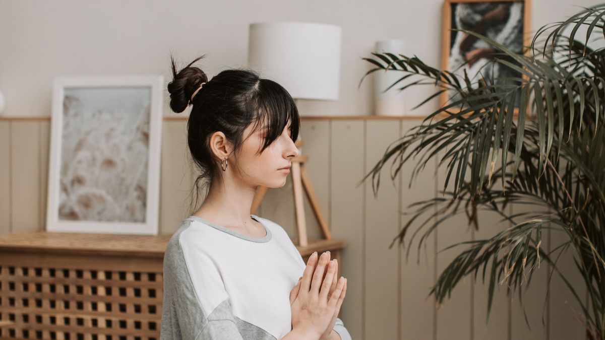 Woman meditating calmly at home away from screens