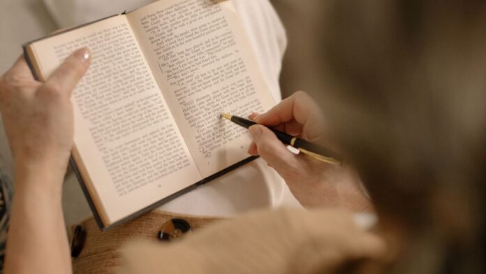 Person relaxing with a book instead of a phone during a digital detox