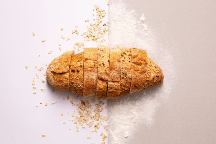 Sliced whole grain bread on a surface, a source of healthy carbohydrates
