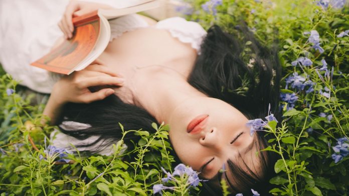 Woman relaxing peacefully outdoors, reflecting with a sense of gratitude