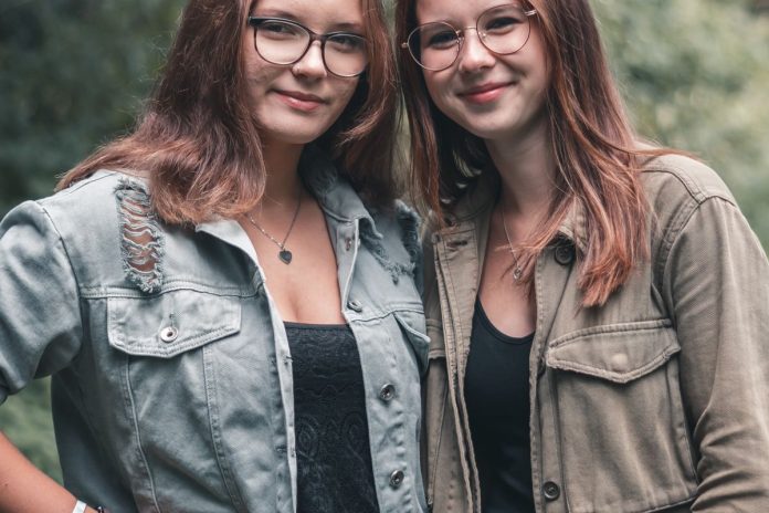 Two adult women smiling together, representing womens health at every life stage