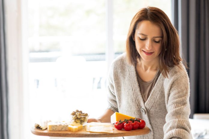 Woman preparing an affordable healthy meal with fruits and vegetables