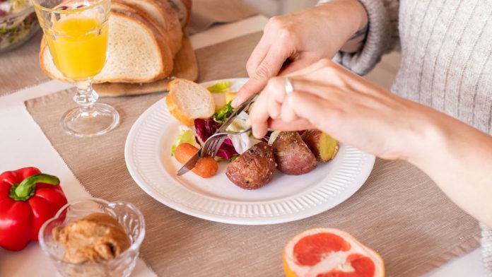 Woman eating a healthy high-protein meal to support weight loss