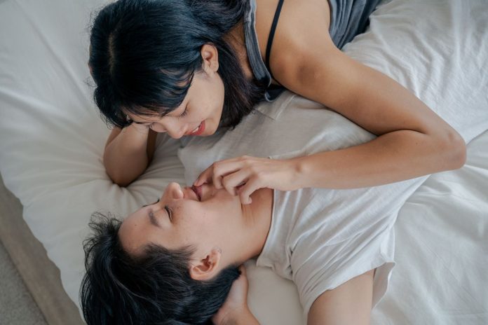 Happy couple embracing together in the bedroom, healthy intimacy and sexual wellbeing
