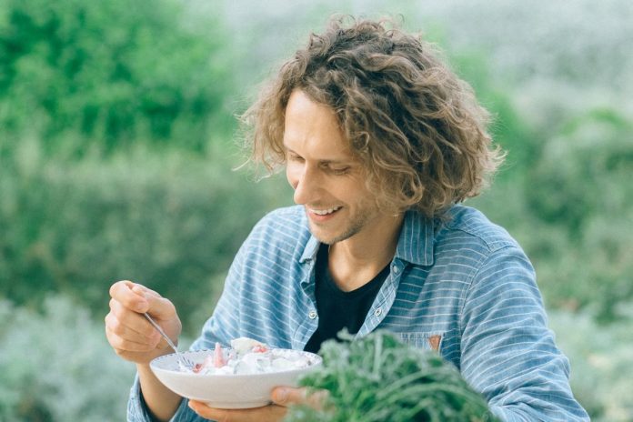 Man eating a healthy salad meal for energy and strength