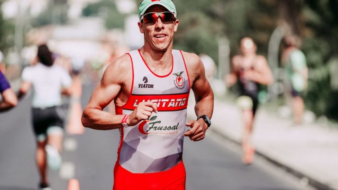 Man running outdoors checking fitness watch to monitor heart rate zones