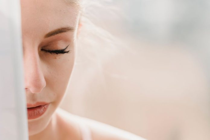 Person sitting calmly with eyes closed, breathing slowly to manage anger and stress