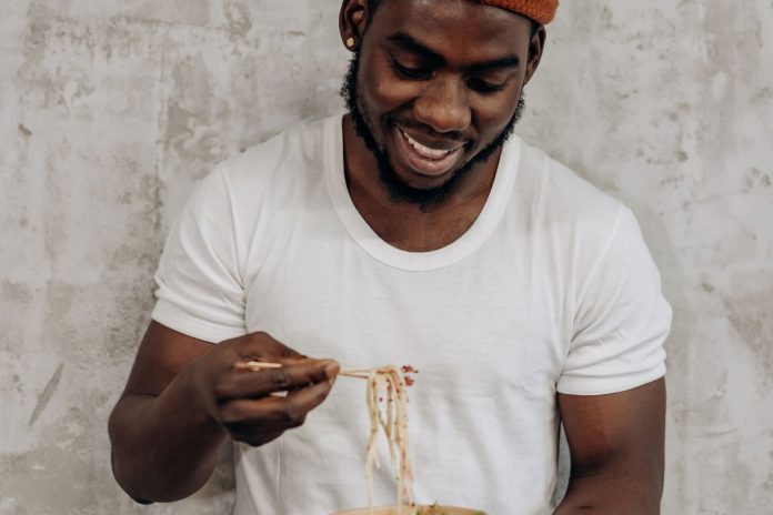 Man eating a healthy rice bowl, supporting good digestion and gut health