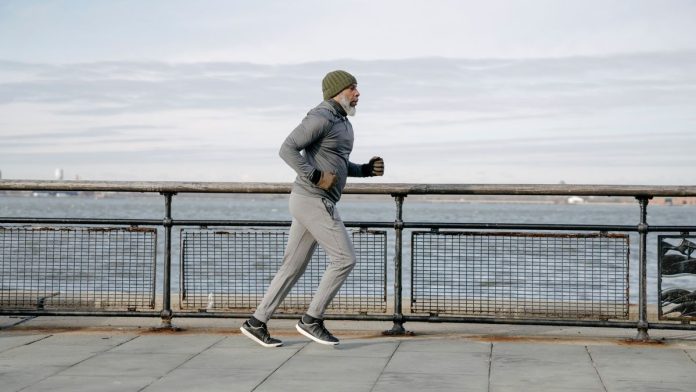 Mature man running outdoors staying active and healthy after 40