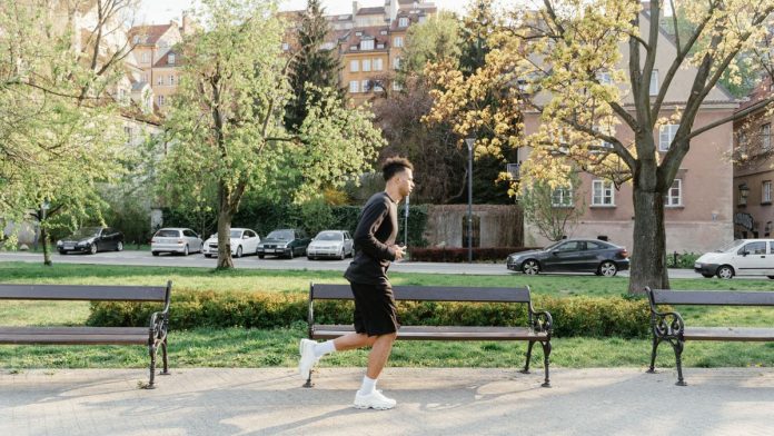Beginner runner jogging outdoors on a path at an easy, conversational pace