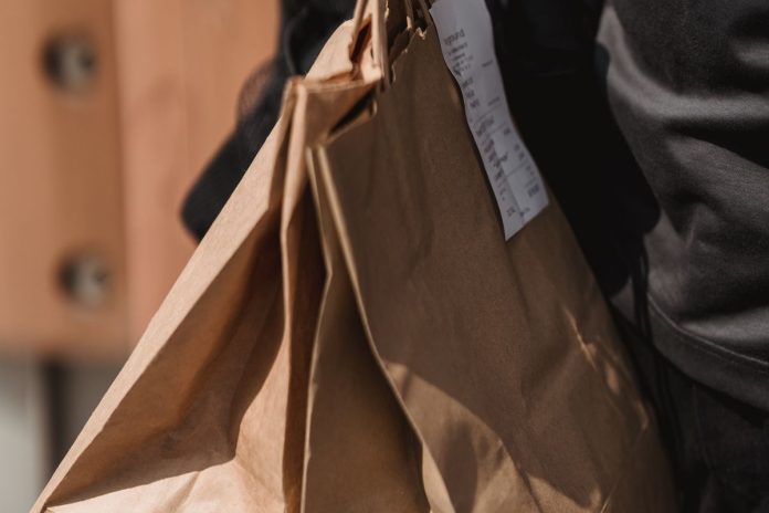 Person carrying grocery bags, an example of functional everyday strength