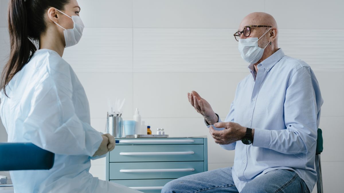 A male patient talking with his doctor about a health concern