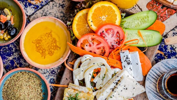 Fresh Mediterranean diet foods including vegetables, olives, and olive oil on a table