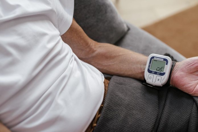 Man using a blood pressure monitor