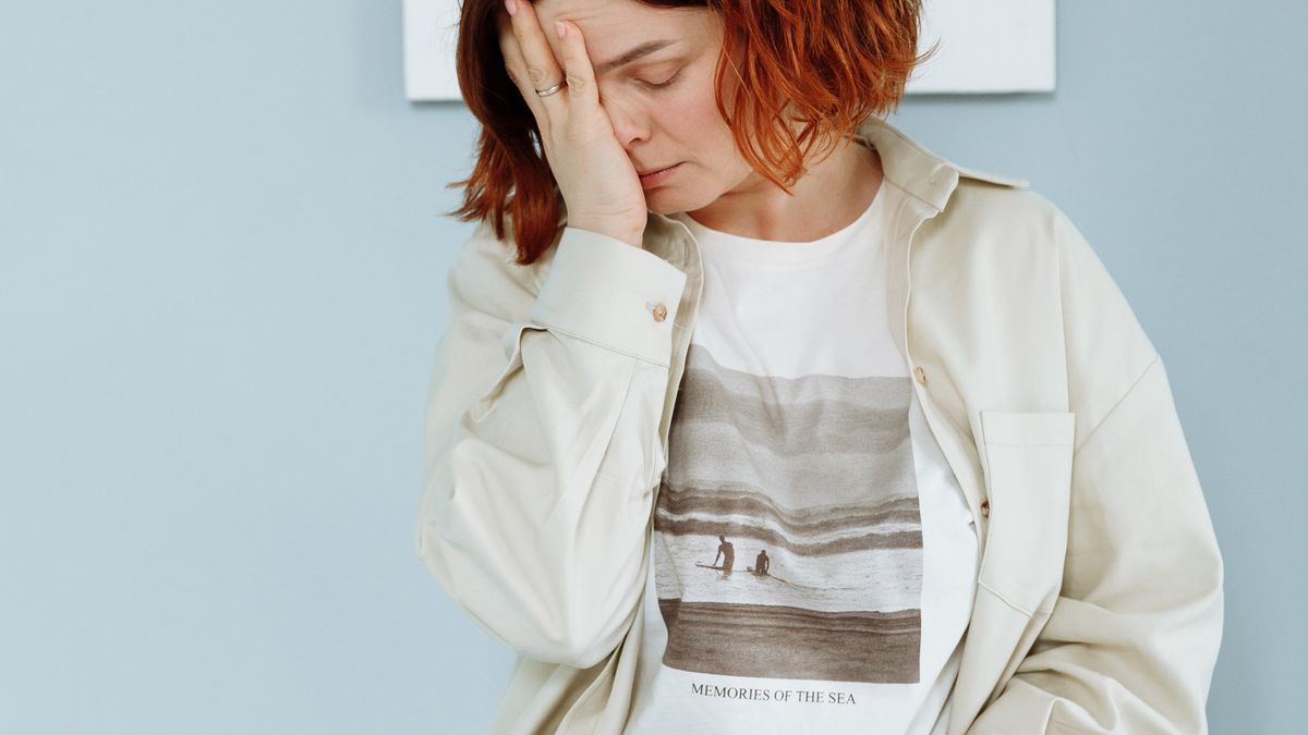 Young woman pausing to think before responding, practicing how to stop people-pleasing