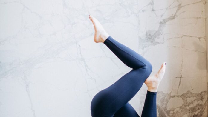 Woman practicing a balancing yoga pose during balance training at home