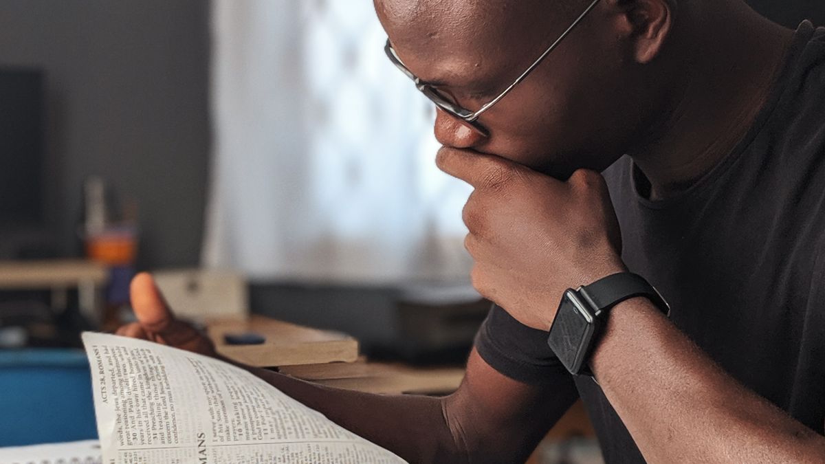 Man reading a book at home to keep his mind sharp as he ages