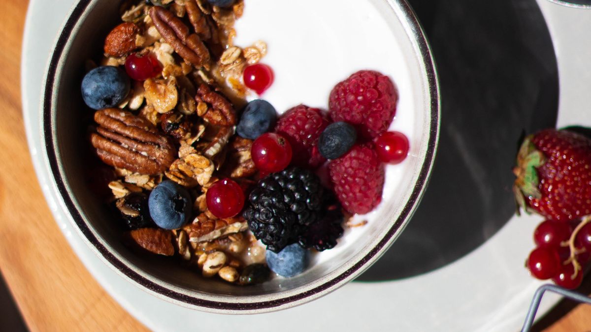 Yogurt bowl with berries and granola, an easy fermented food to add for gut health