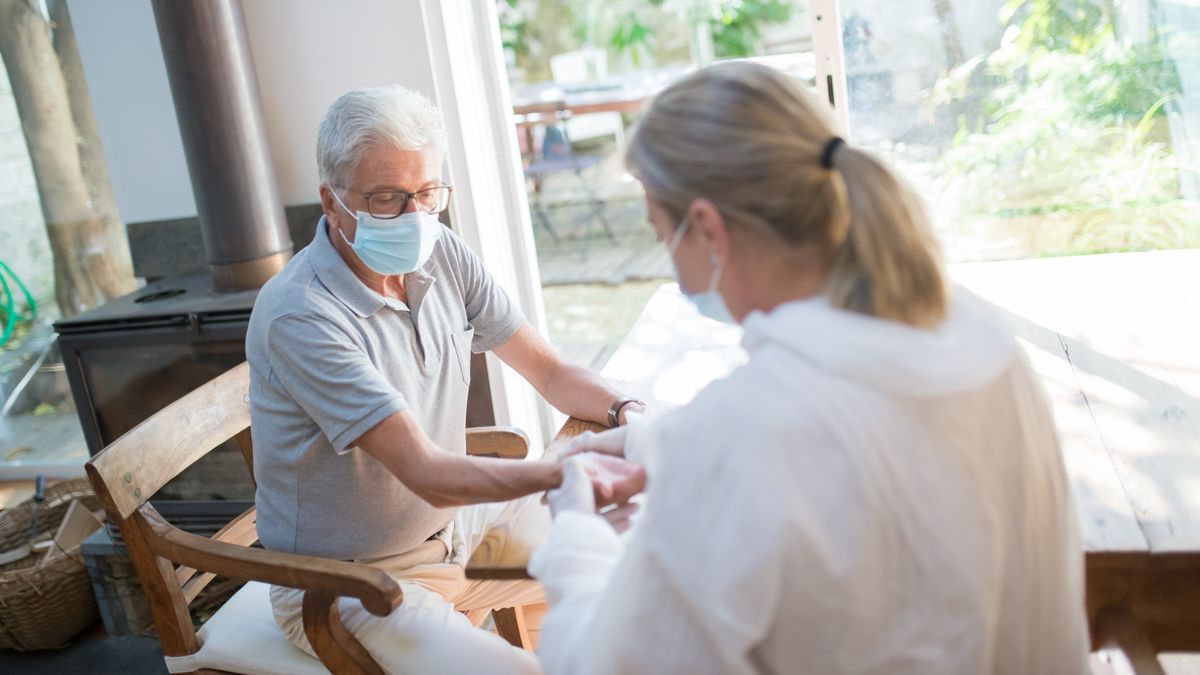 Doctor examining a man for signs of an inguinal hernia