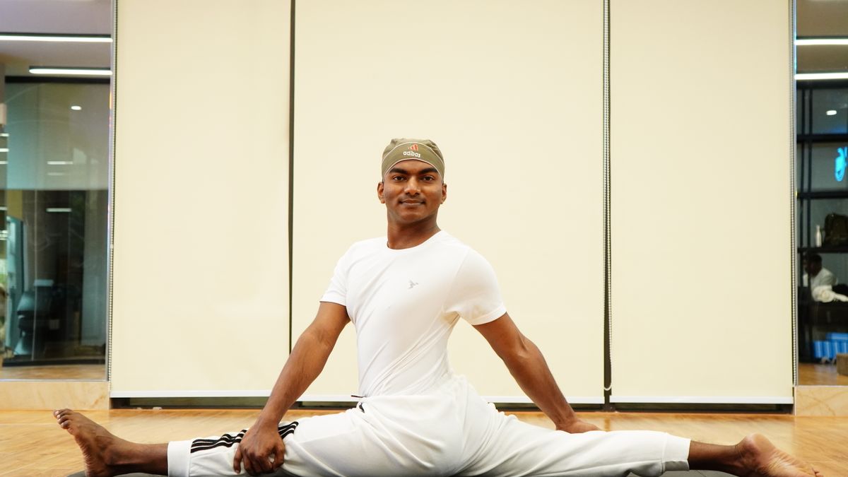 Man stretching his legs on a yoga mat during a recovery session