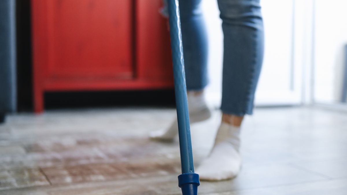 Person mopping the floor, burning calories through housework