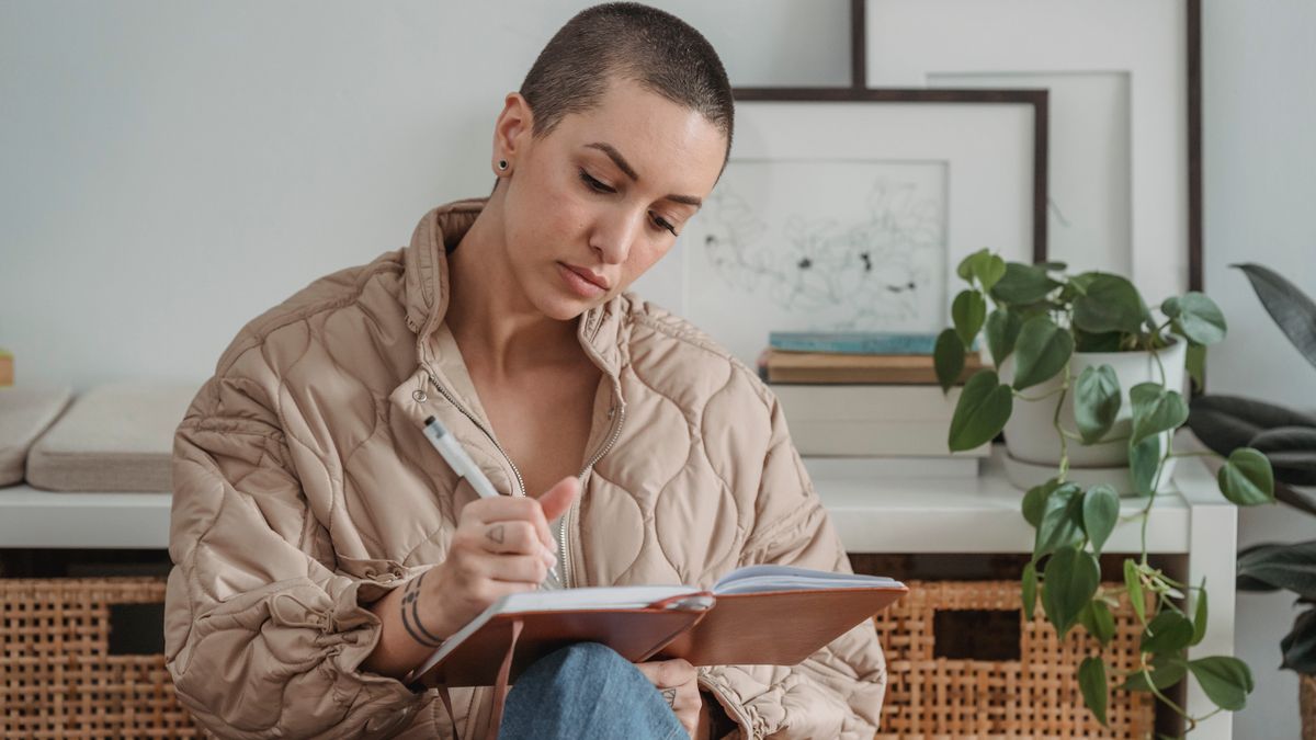 Woman journaling to challenge perfectionist self-talk