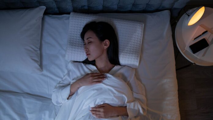 Woman sleeping in on a weekend morning, an example of social jet lag from a shifted sleep schedule