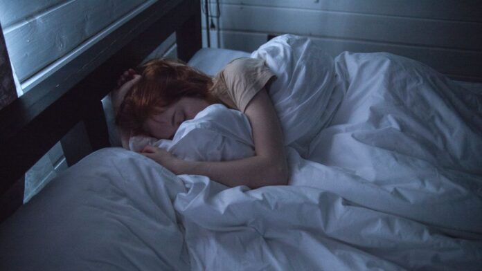 Woman sleeping peacefully in bed at night