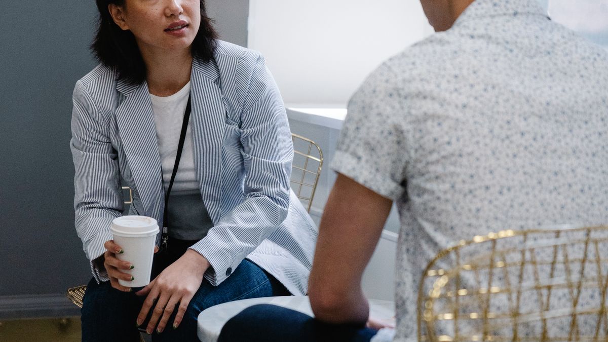 Two friends talking over coffee, one way to ease emotional numbness