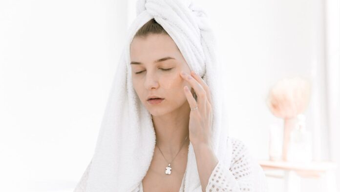 Woman in a bathrobe caring for herself at home, illustrating everyday vaginal health habits