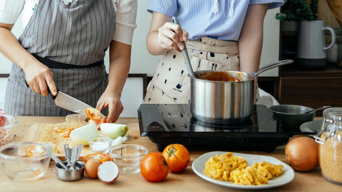 Woman cooking a pot of legumes on the stove for a plant protein meal