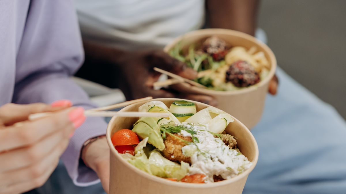 Two people enjoying large bowls of healthy food while eating for volume